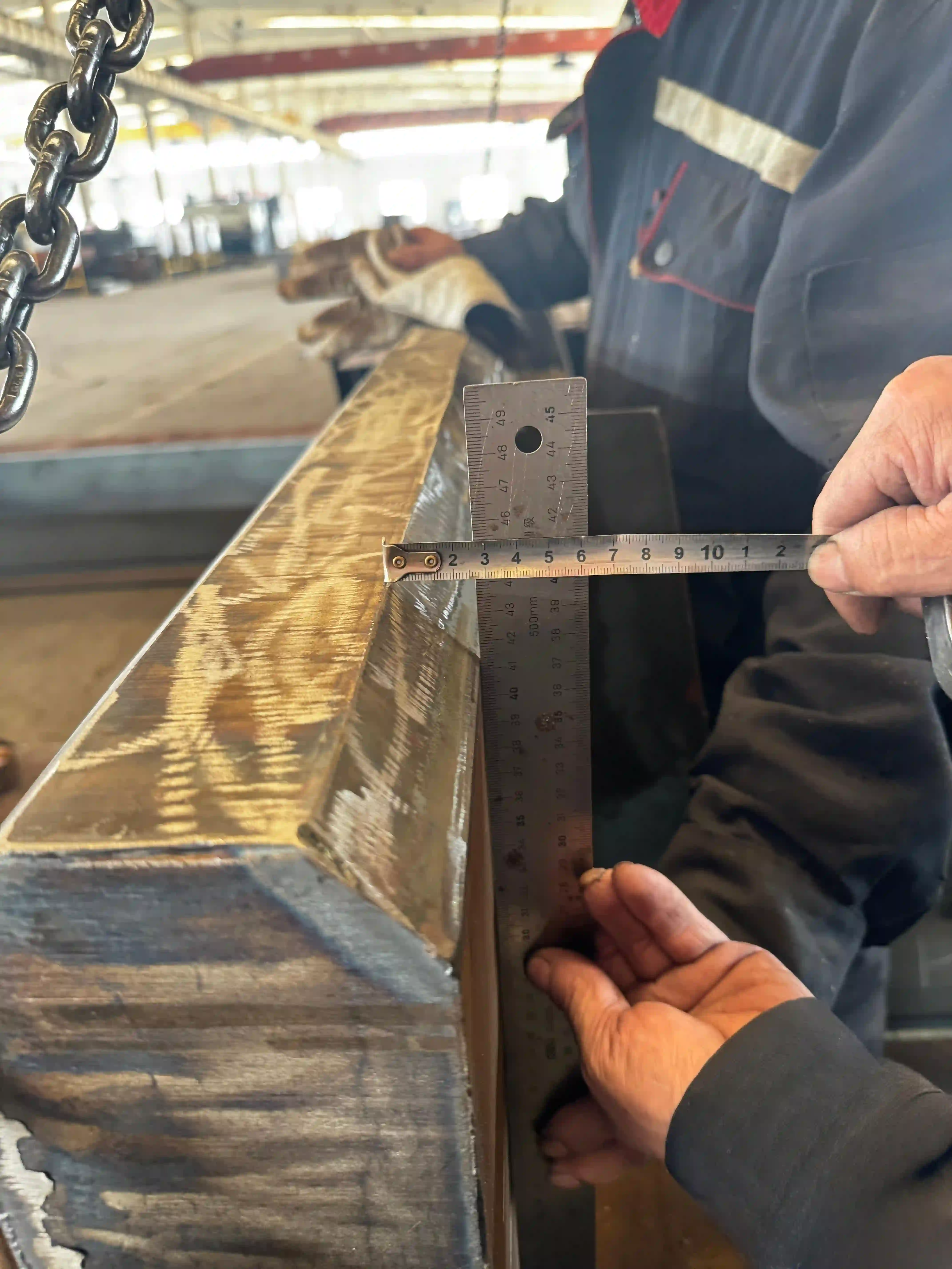Third-party surveyor reviewing plate surface quality before shipment