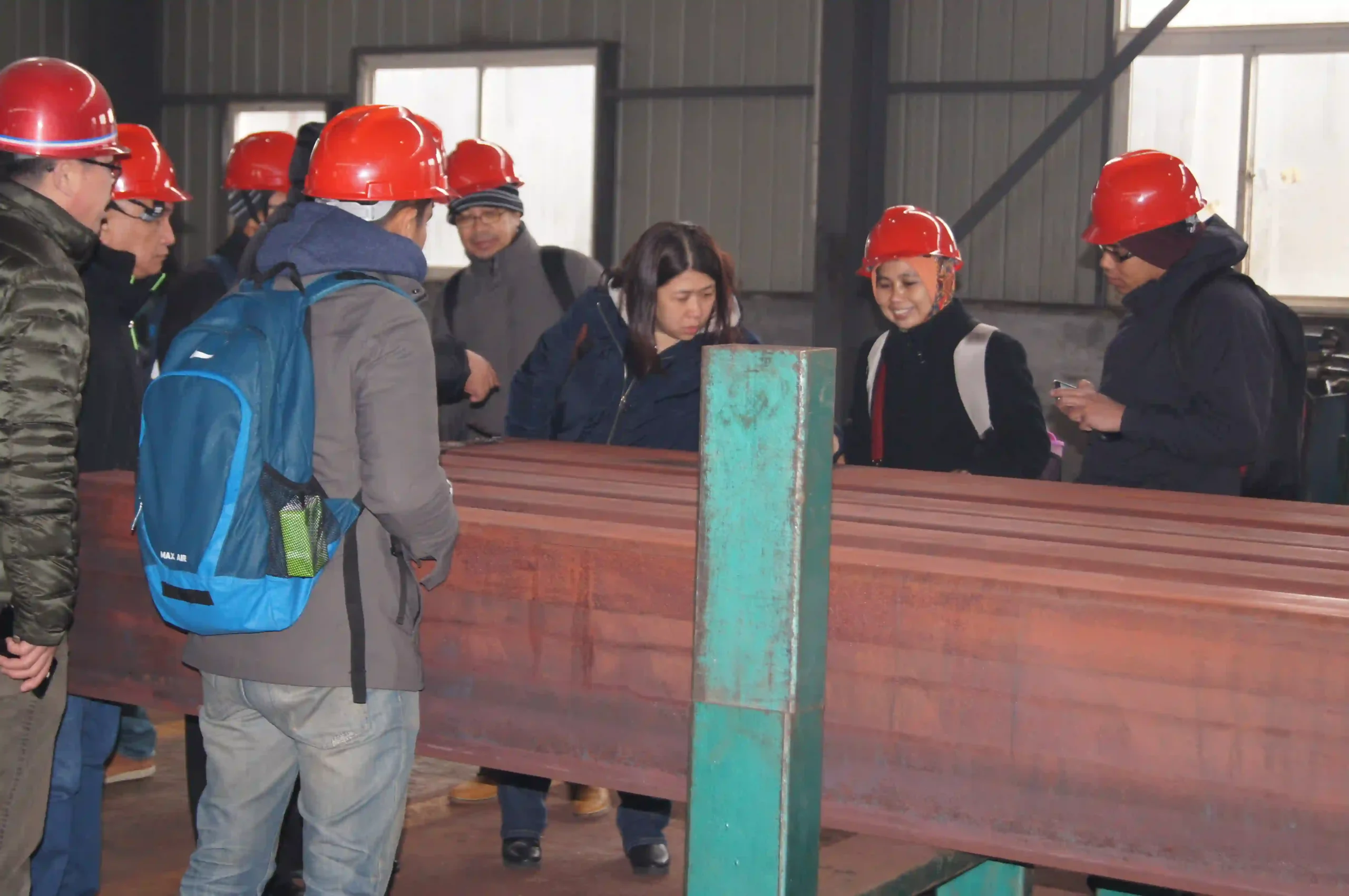 Client reviewing cut-to-size wear plate parts at the factory