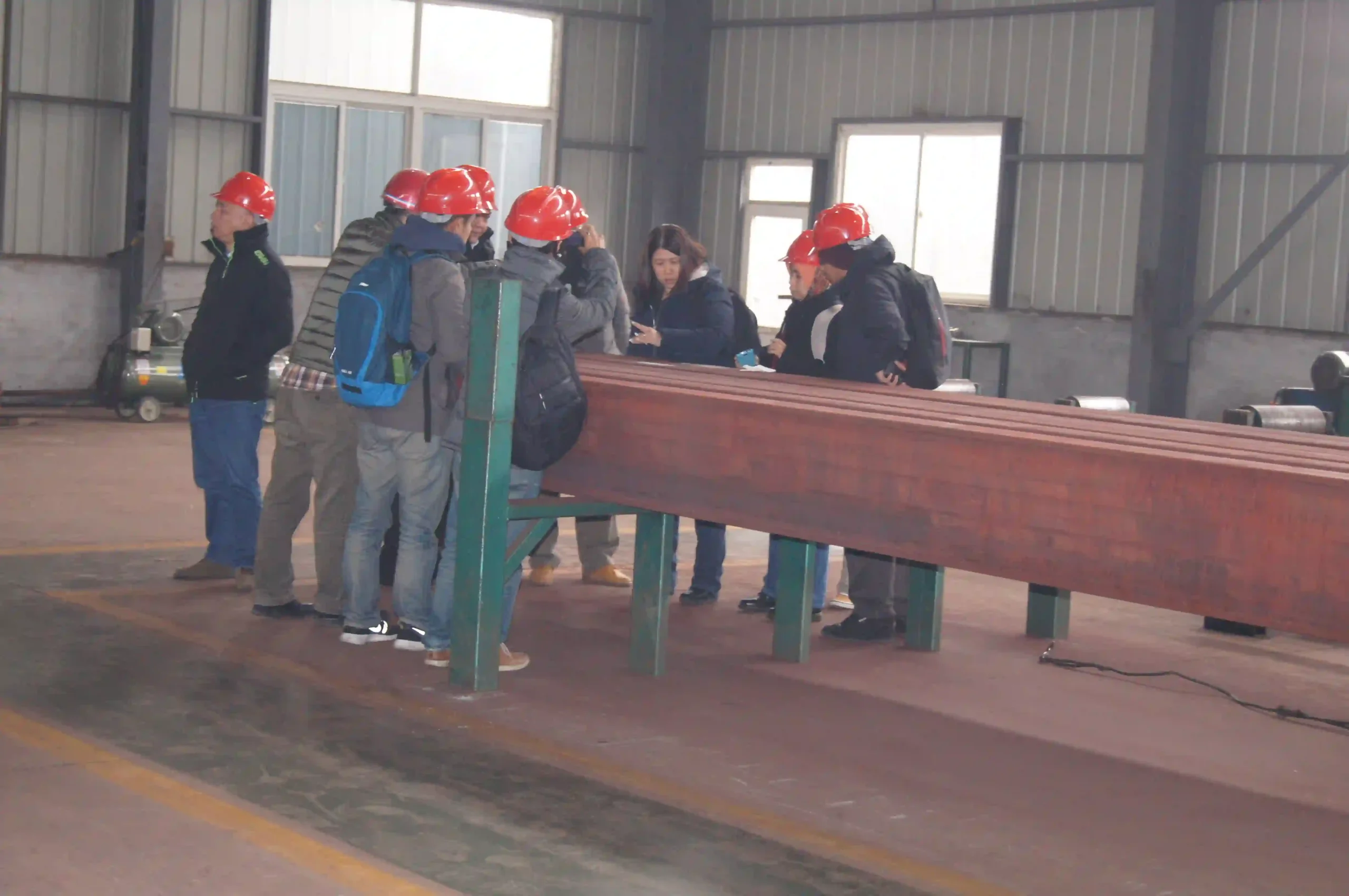 Third party inspector measuring plate thickness in the warehouse