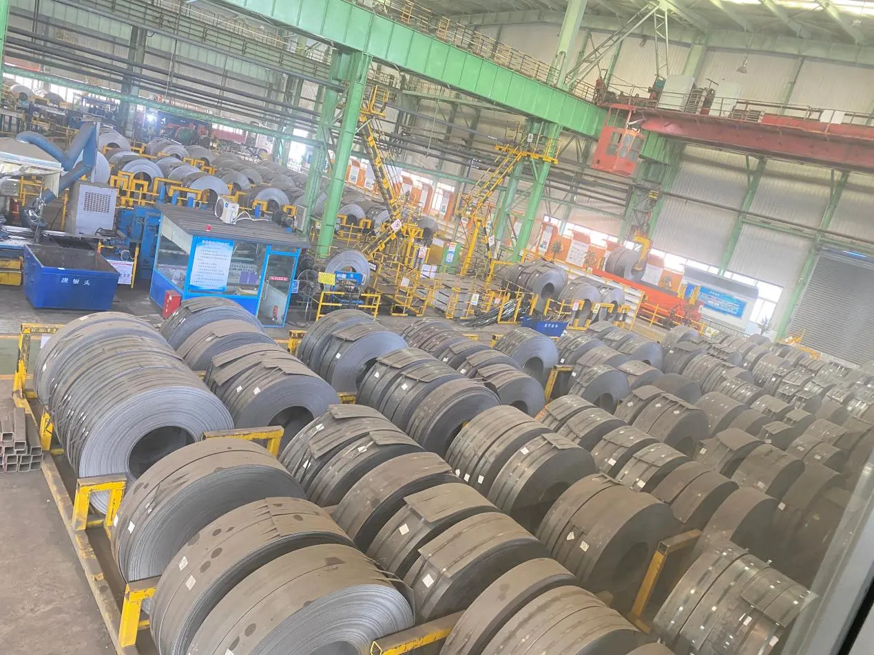 International customers walking through the steel plate storage warehouse during a factory audit