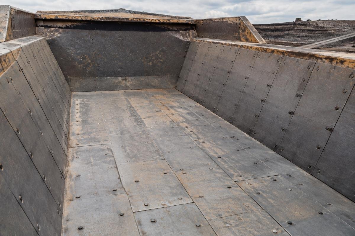 Haul truck bed lined with AR400 wear plates showing minimal damage after extended use