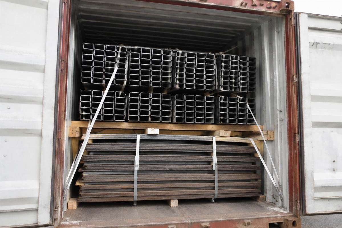 Photo of a mixed container load showing steel plates at the bottom and hollow sections stacked securely on top